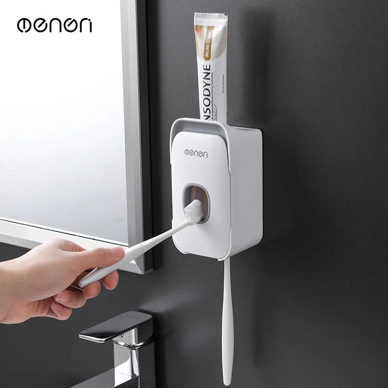 Wall-mounted automatic toothpaste dispenser in blue, grey, and pink colours