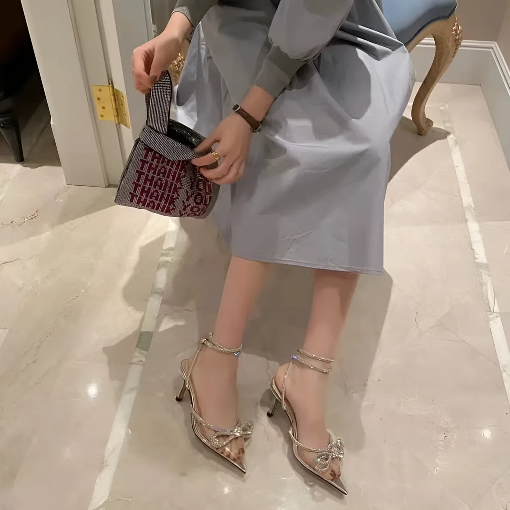 Women's stiletto heel sandals with a silk bandage back, buckle strap, and pointed toe in various colours.