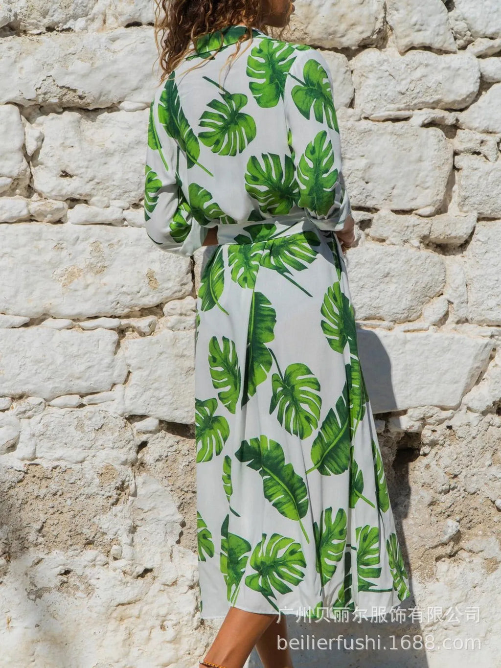 V-neck chiffon dress with printed pattern and A-line skirt on a hanger.
