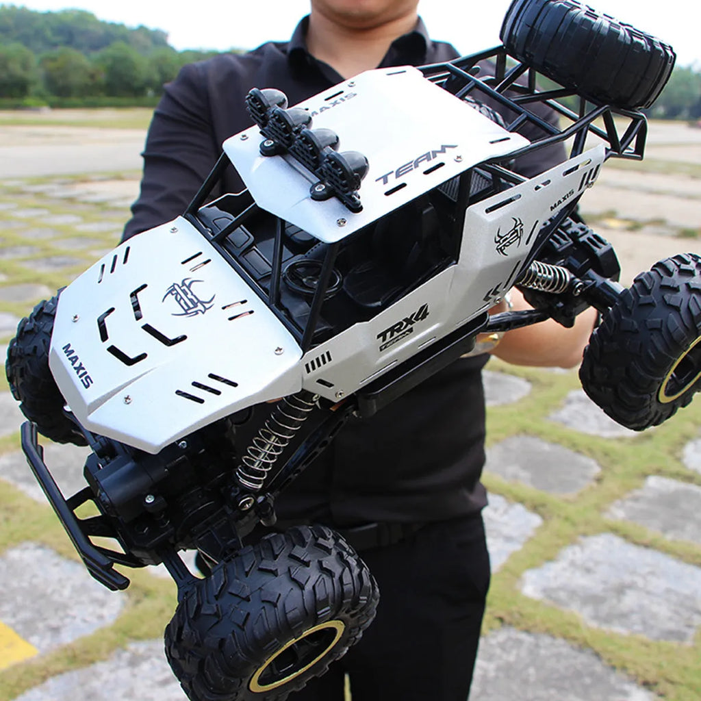 Large black 4WD remote control climbing car and a smaller silver high-speed RC car with wireless remotes