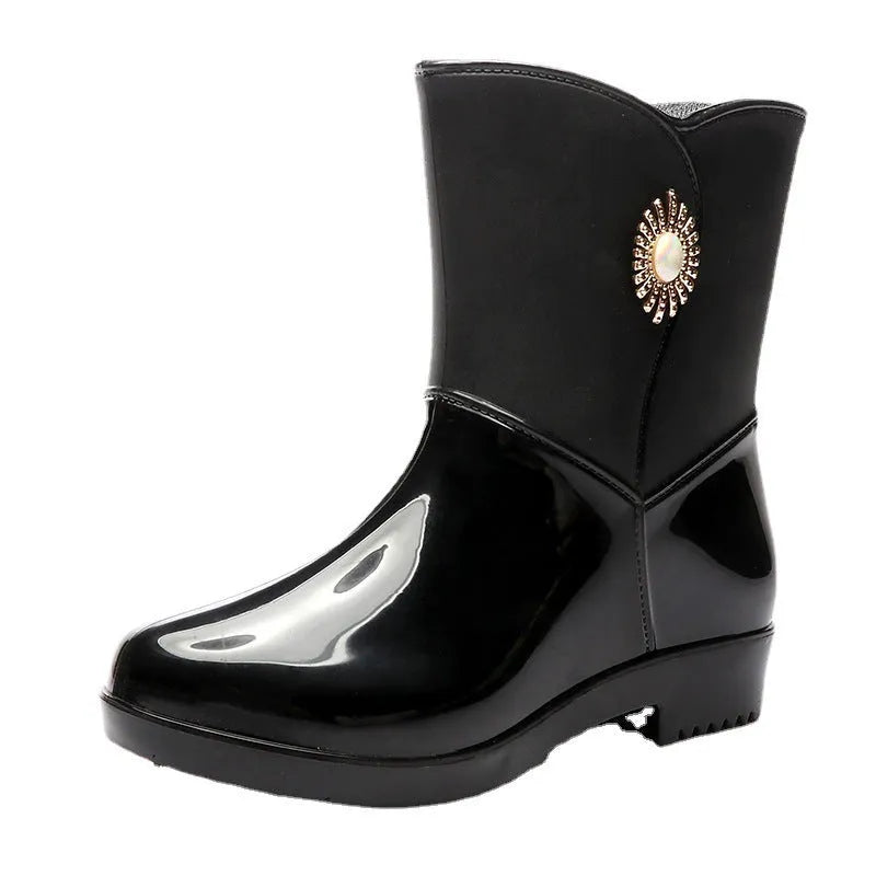Women's middle tube PVC rain boots in beige, black, and purple with a non-slip sole.