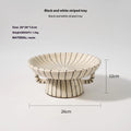 Black and white striped retro resin fruit plate on a table.