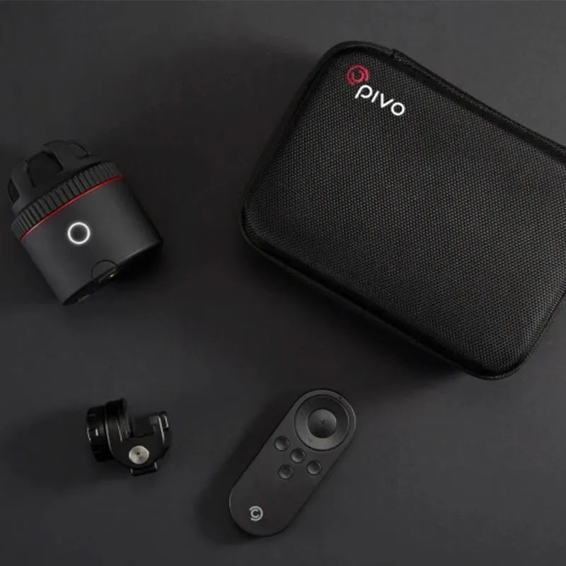 Black PIVO facial tracking smartphone mount on a table, showing 360-degree rotation mechanism.
