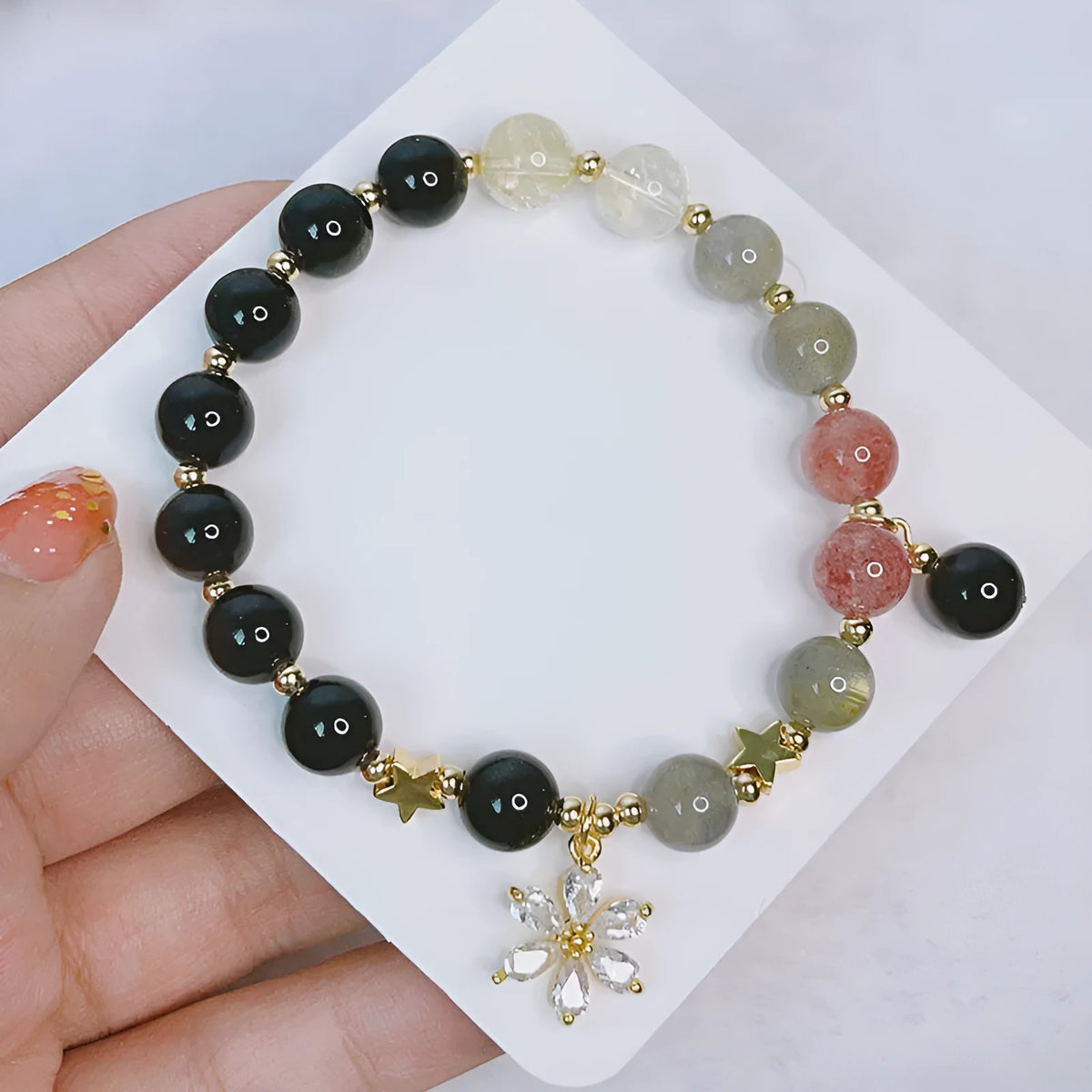 Women's silverstone bracelet with electroplated finish showing floral, love, and star charm designs