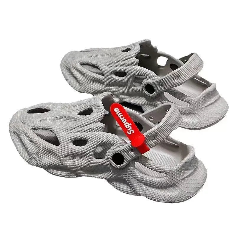 Grey EVA coconut-style slippers with closed toe, perforated holes, and a frosted texture on a solid background.