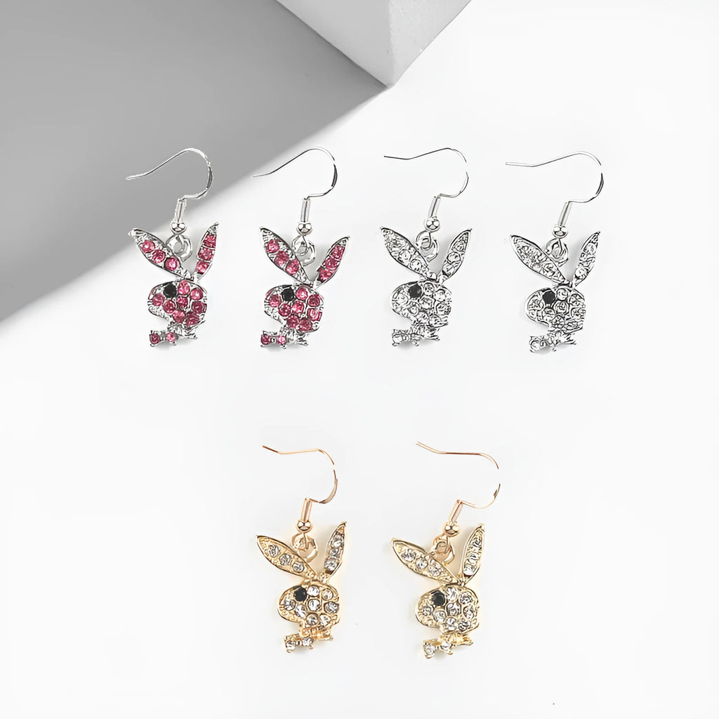 A pair of cartoon rabbit stud earrings with a full diamond design, shown in gold, pink, and silver colour options.