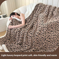 Double-layer taffeta blanket with reversible leopard jacquard print design shown in camel colour