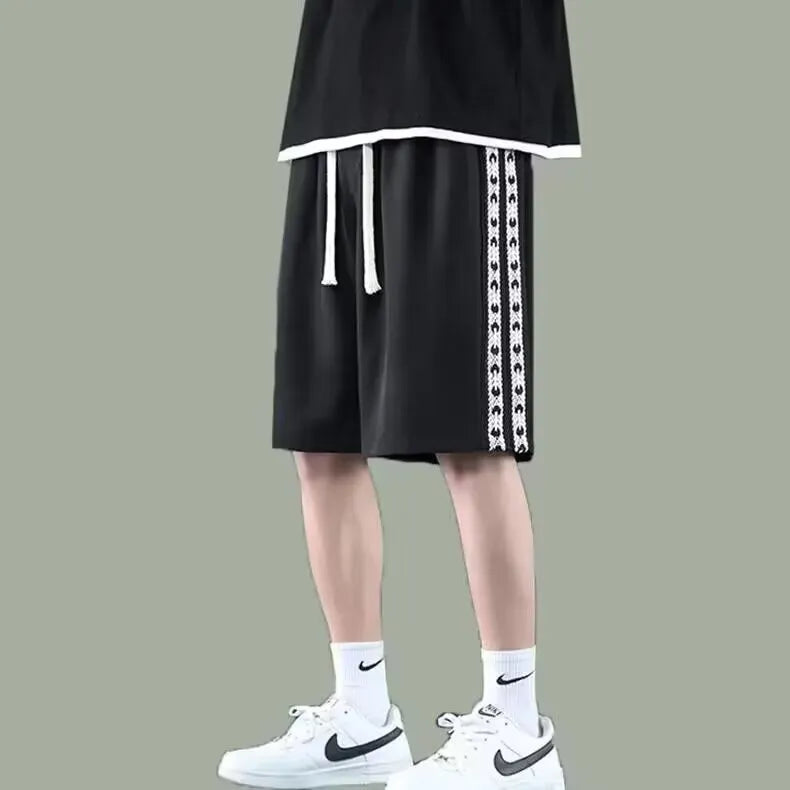 Men's black baggy track pants with loose fit and elasticated waistband for casual sports wear