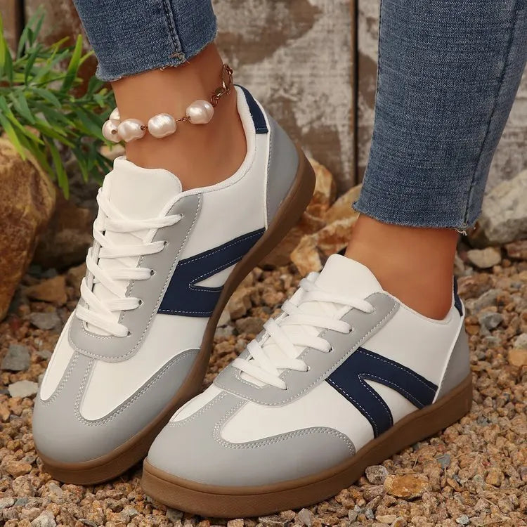 Blue women's low-top hiking shoes with artificial PU upper and rubber sole on a natural background.
