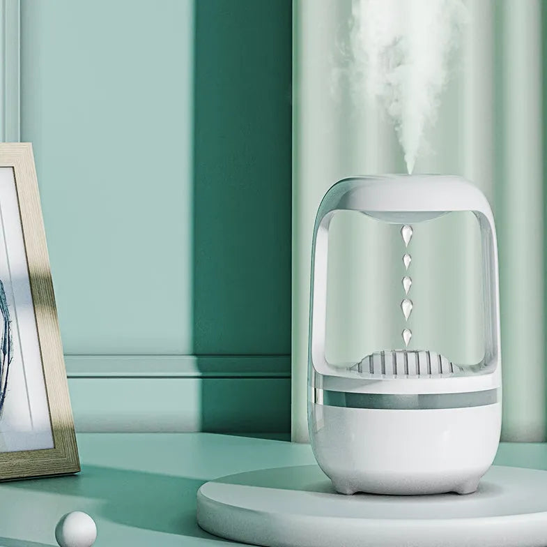 White anti-gravity humidifier showing water drop backflow effect with USB cable connection