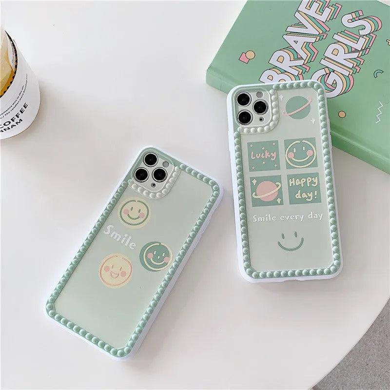 Green TPU iPhone case with geometric pattern and smiley face design in a polka dot frame.