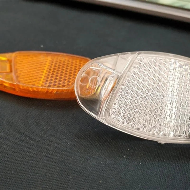 White and yellow bicycle spoke reflector safety decorations measuring 7.2cm by 3.5cm