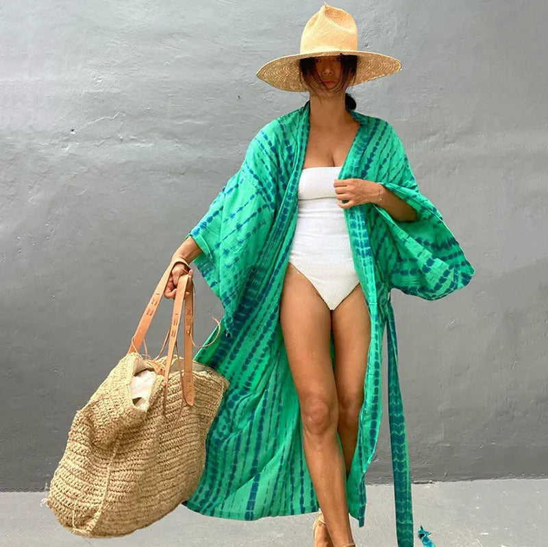 A printed, loose-fitting cotton beach cover-up blouse on a hanger, shown in a rust red colour from the DN0712 series.