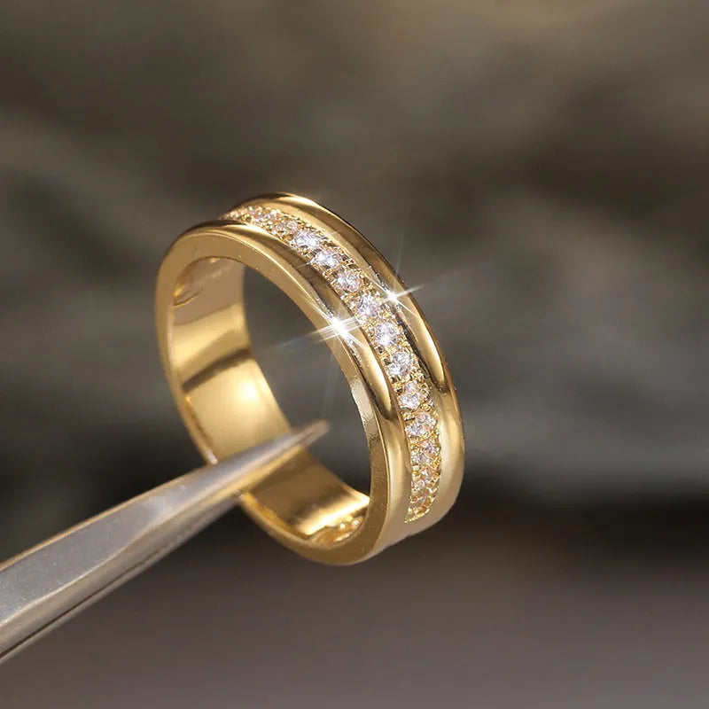 Gold plated copper geometric ring with inlaid zircon stone on white background