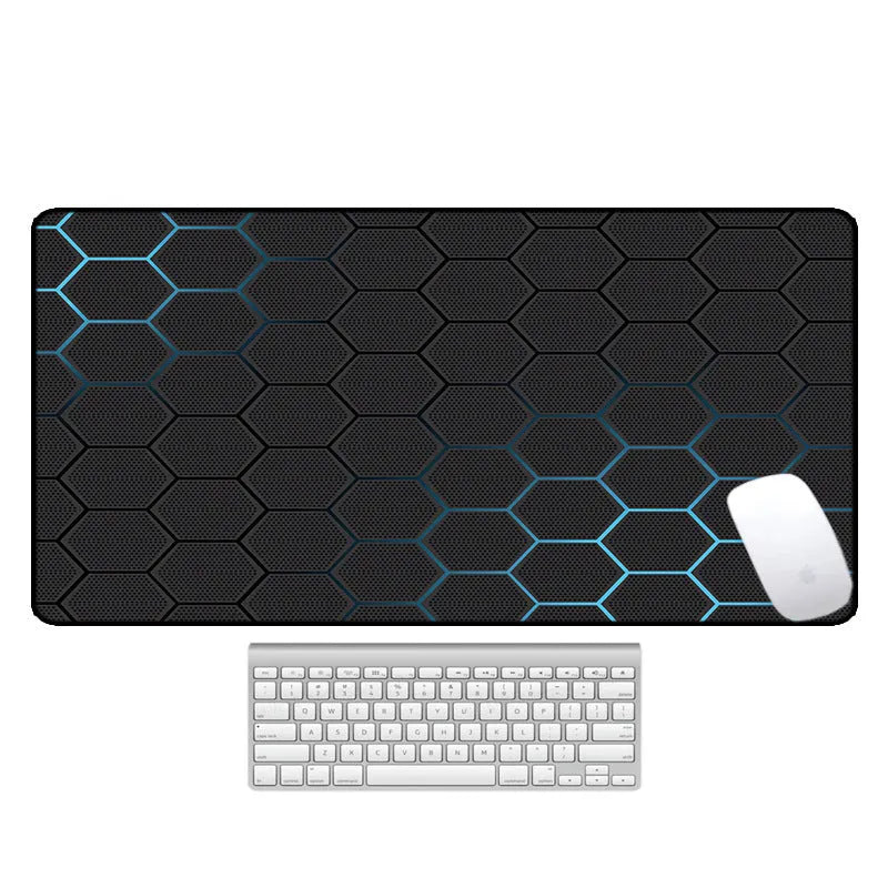 Large rectangular desk mouse pad with graphic pattern and natural rubber non-slip base on a wooden desk.