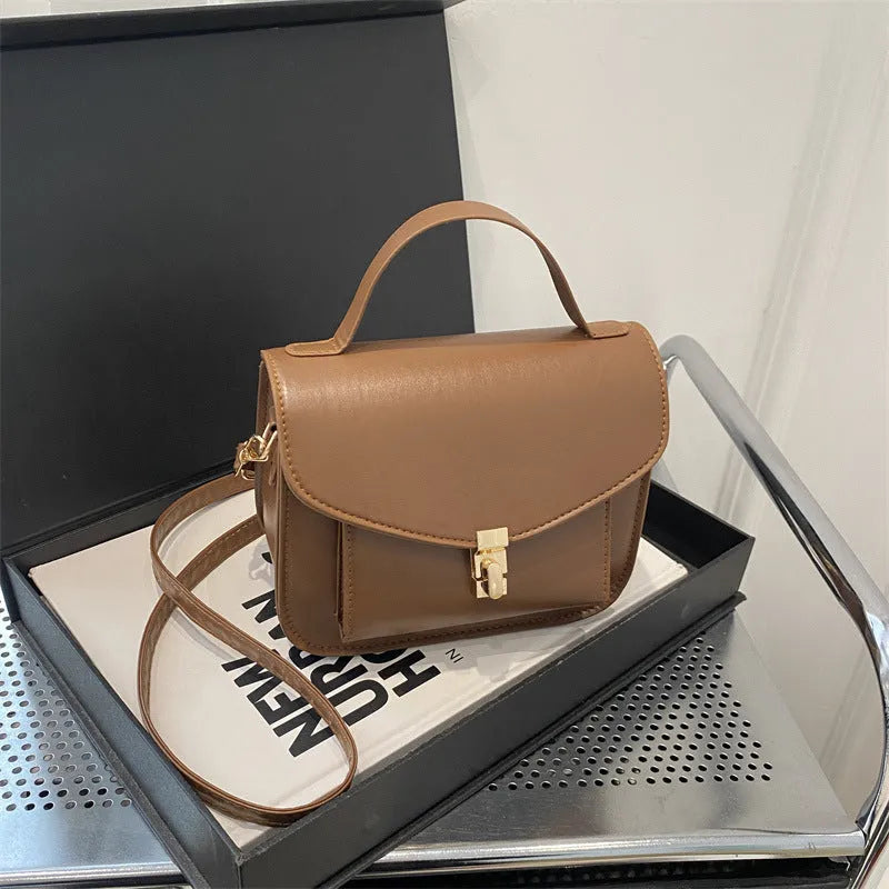 Shoulder messenger bag in horizontal square shape with sewing line detailing and crossbody strap