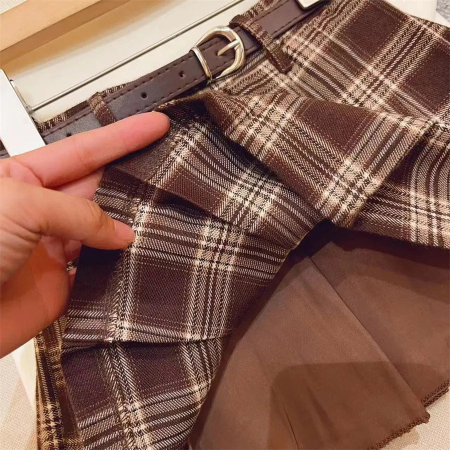 Girls' cotton plaid pleated skirt in A-line style showing pleat detail and plaid pattern
