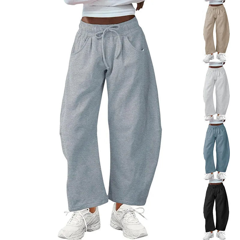 Loose cropped sweatpants with drawstring waist in apricot colour showing side pockets and street fashion styling