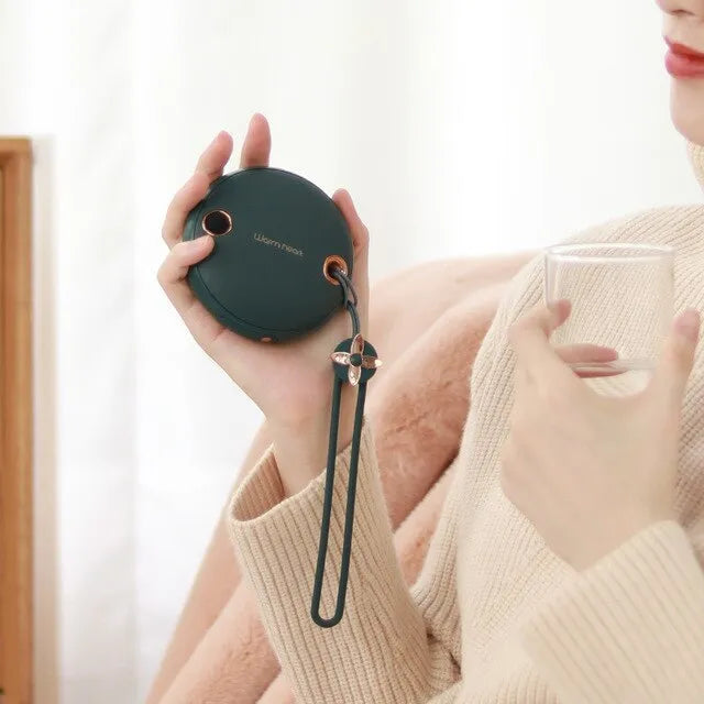 Green 5000mAh hand warmer power bank with digital display, shown next to its included USB charging cable.