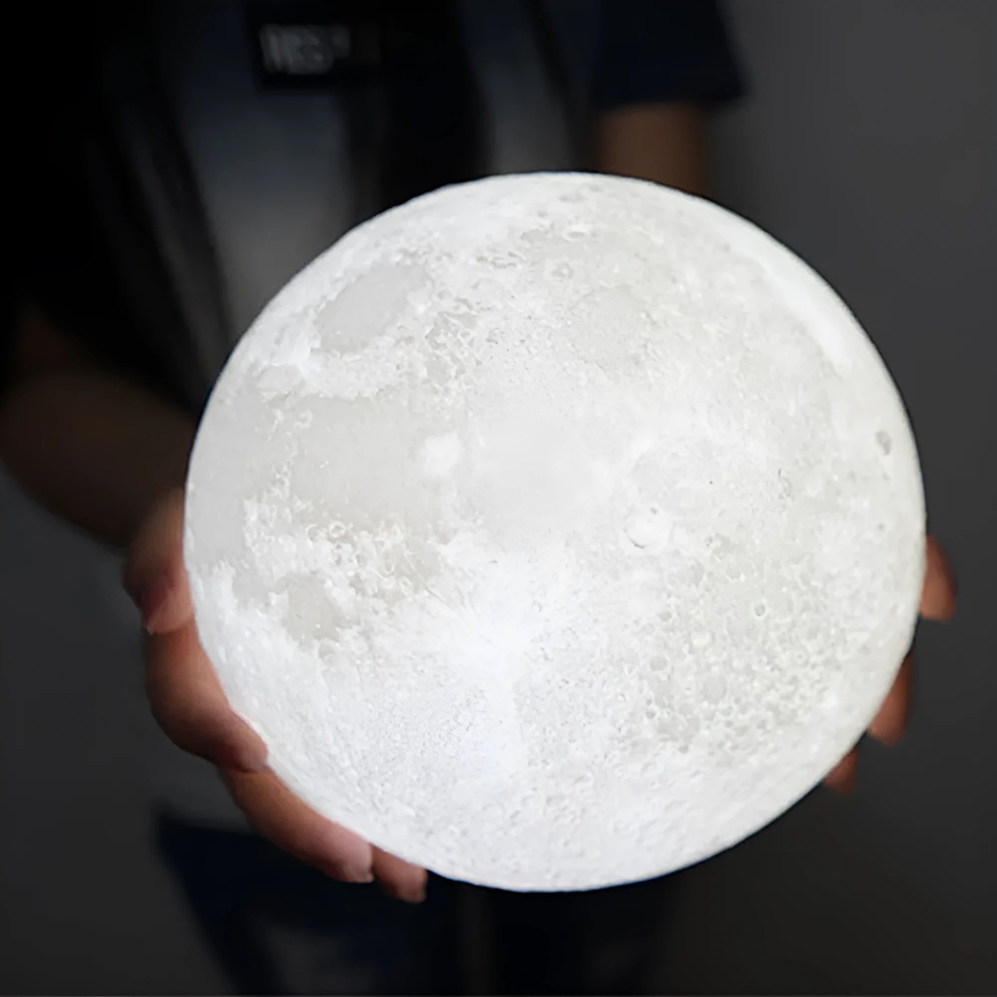 3D printed white moon lamp on a wooden stand with touch control ring at base