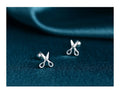Pure silver screw-back ear nails featuring a miniature scissors charm