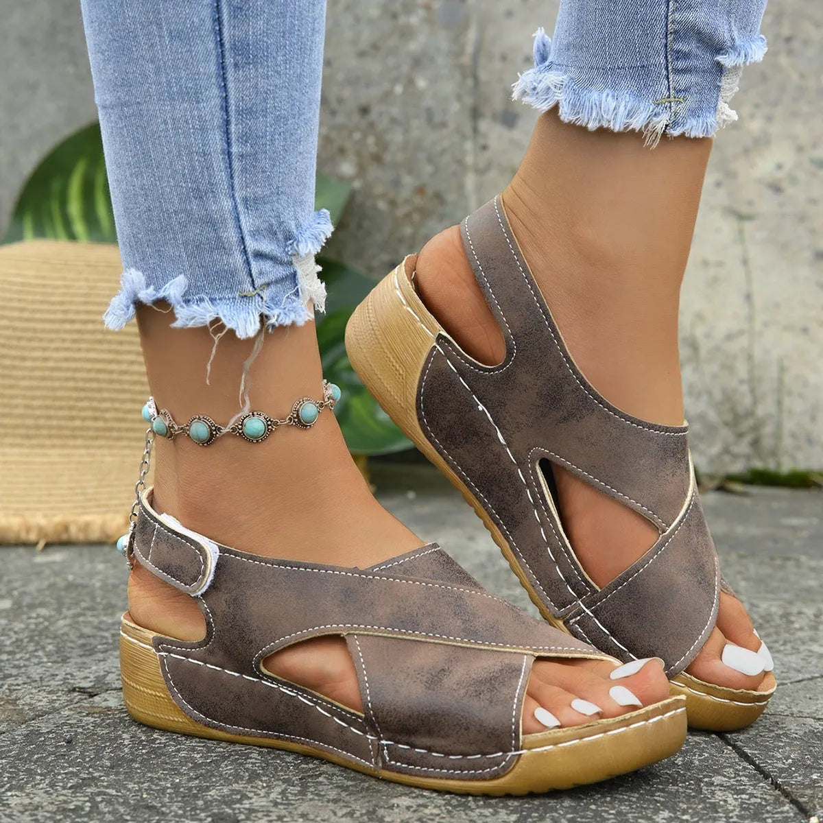 Women's brown roman platform sandals with a skirt detail and velcro strap fastening on a white background