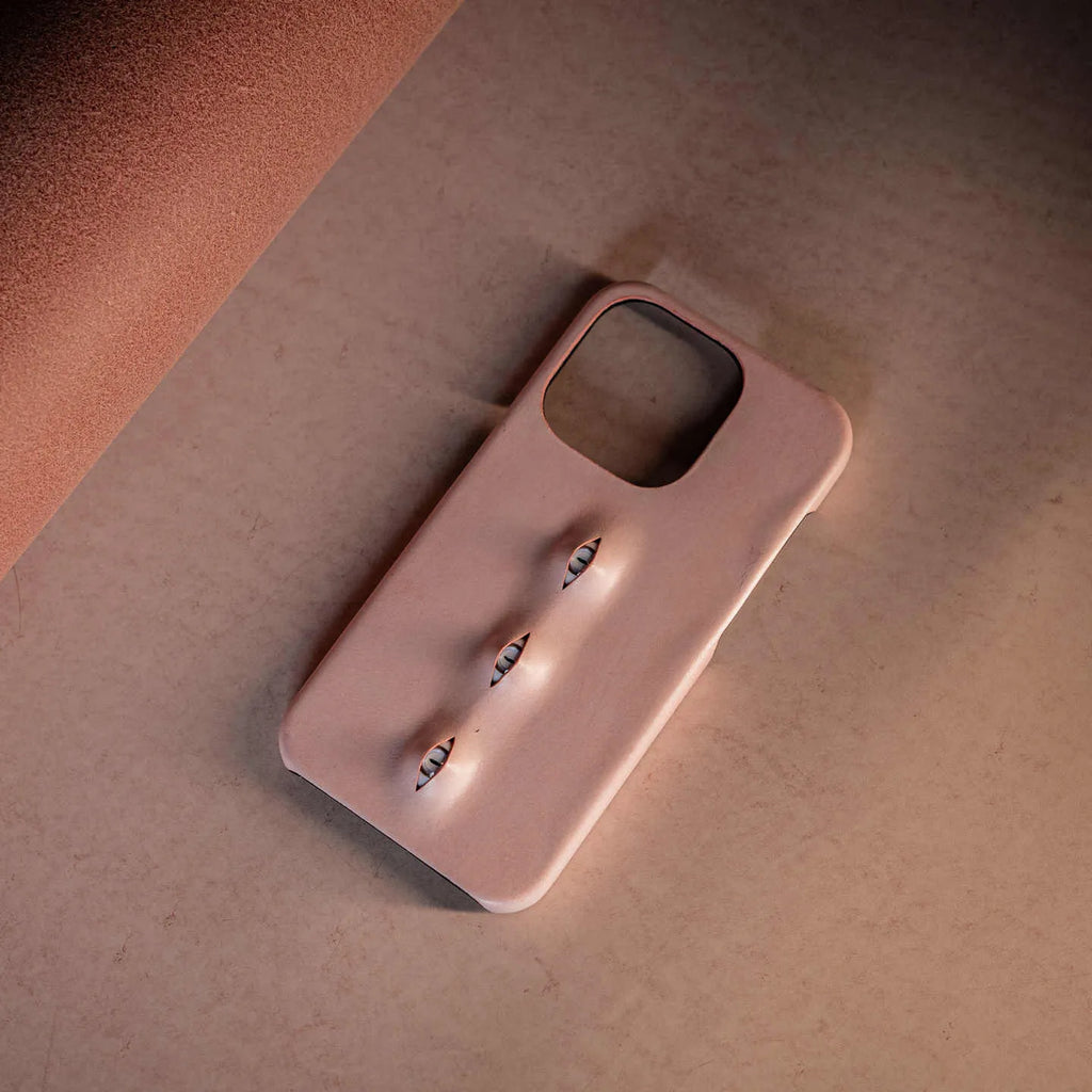 Pink eye-shaped handmade iPhone case in waxed vegetable-tanned cowhide with PC bottom case