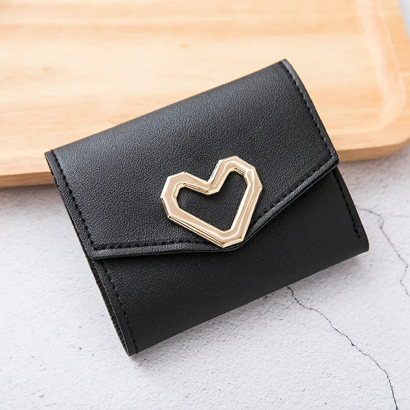 Ladies tri-fold PU leather wallet with magnetic buckle, card slots, ID space, coin pocket, and heart decoration