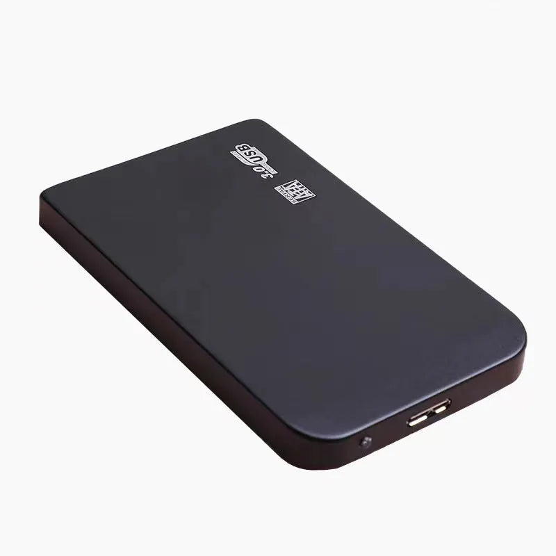 Black USB 3.0 portable solid state drive with metal housing on a desk.