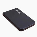 Black USB 3.0 portable solid state drive with metal housing on a desk.
