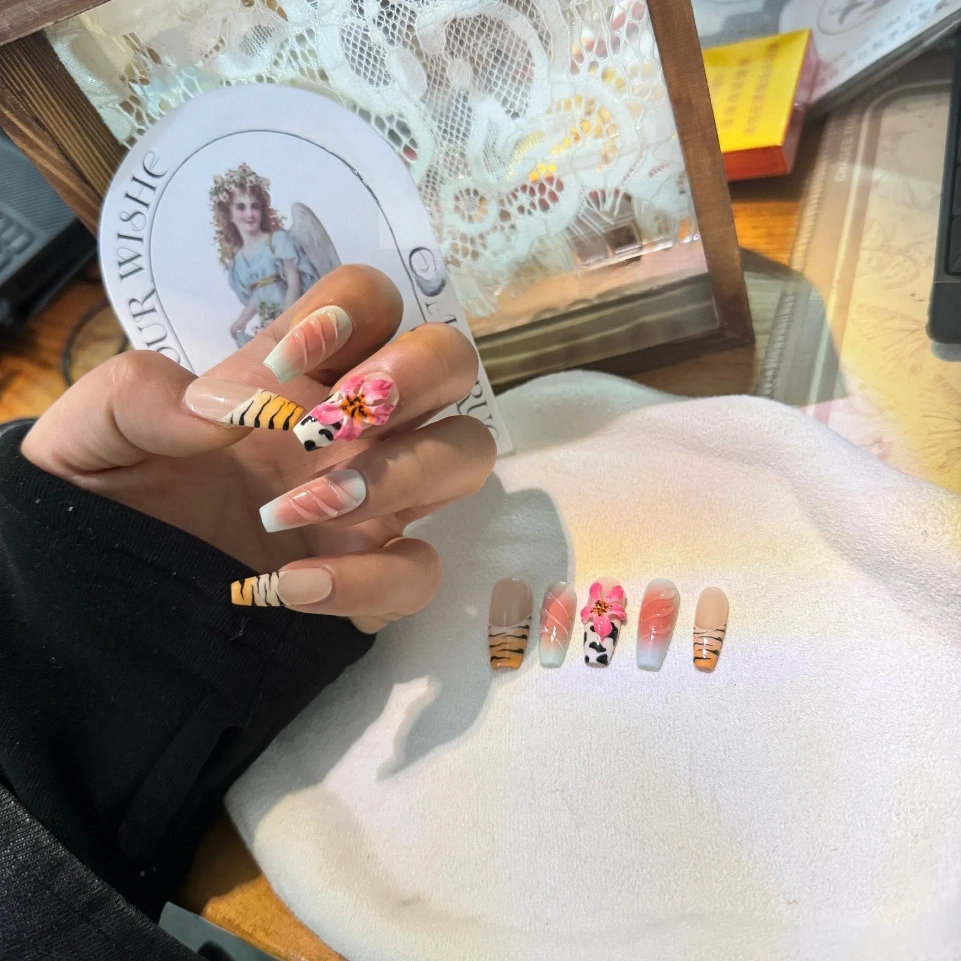 Hand-carved zebra pattern lily nail art set showing floral, leopard print and embossed designs in multiple sizes