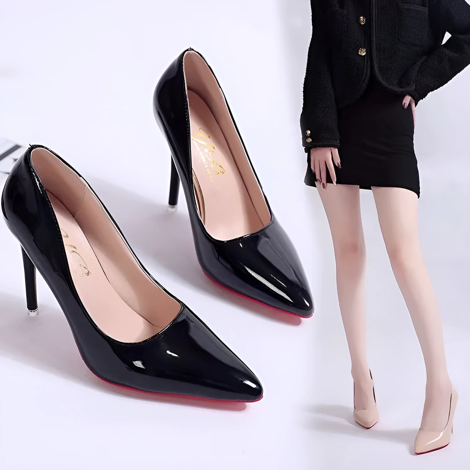 Women's black pointed toe stiletto pump with a shallow mouth on a rubber sole.