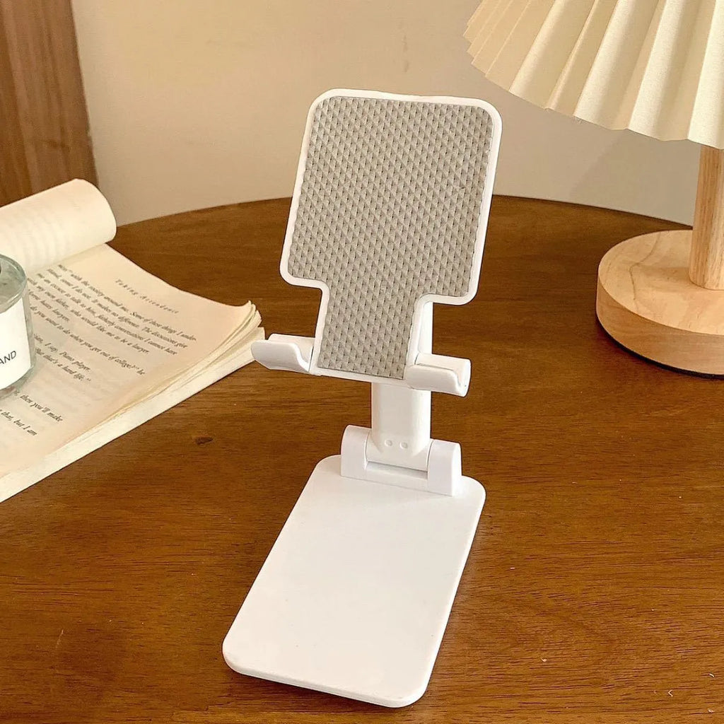 Folding universal plastic mobile phone stand in pearl white, deep black, mint green, and girl pink