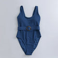 Navy blue women's one-piece triangle swimsuit on a hanger.