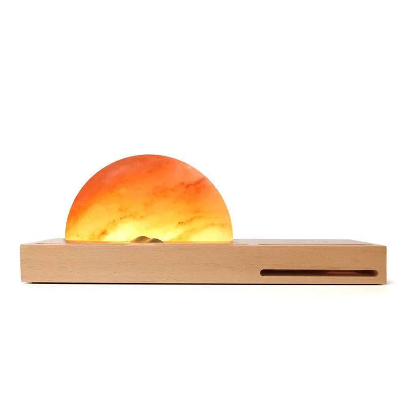 Natural crystal salt lamp with beech wood base featuring integrated wireless phone charging.