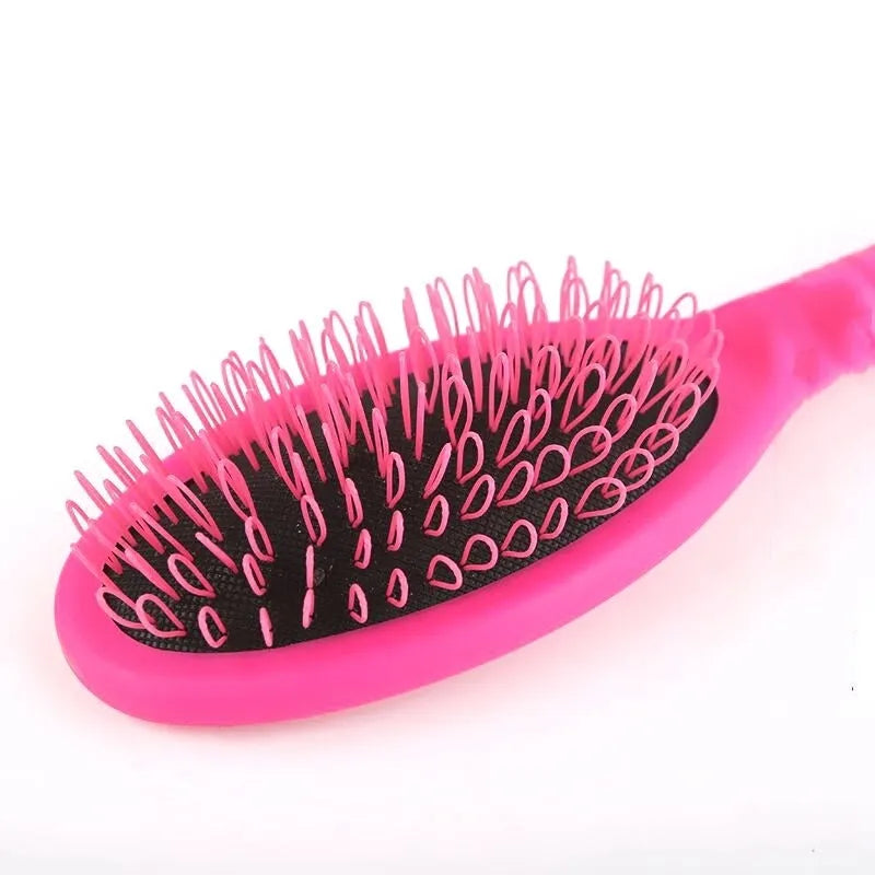 Black ring tooth hair extension comb with airbag cushioning on white background