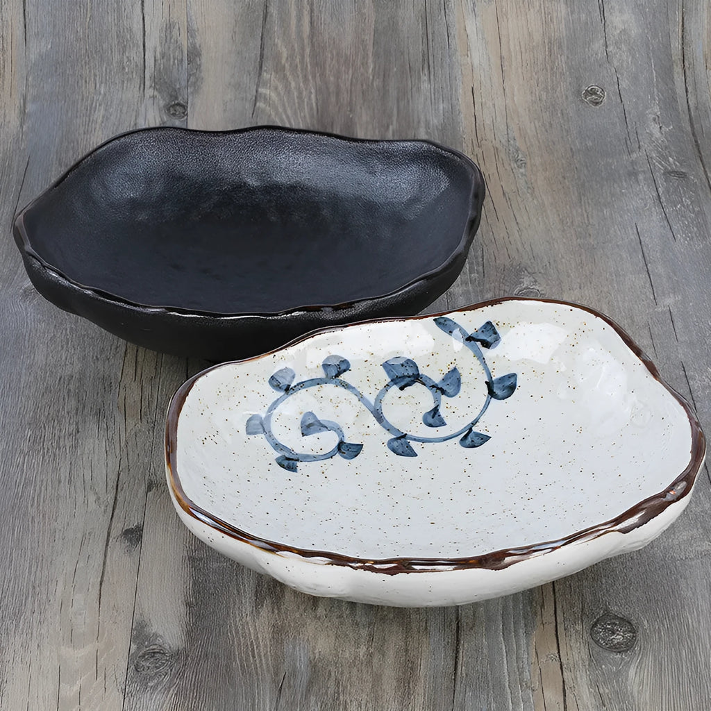 Japanese style irregular shaped ceramic sashimi bowl with floral decoration and matching sauce dish