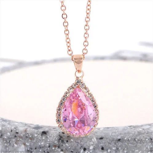 Drop-shaped pendant necklace with rhinestone and gemstone inlay in pink colour option