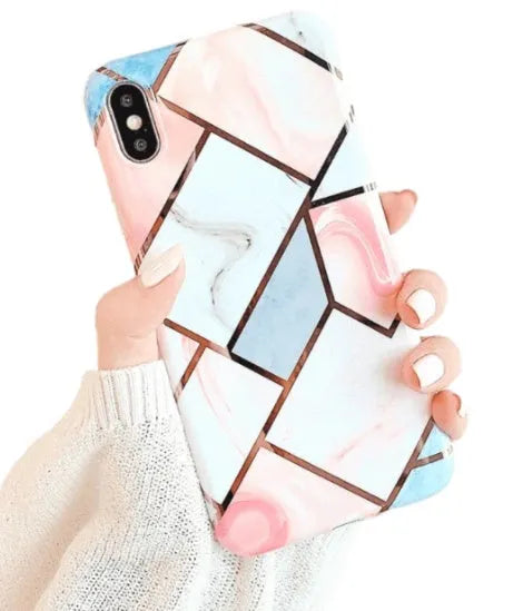 Flexible silicone mobile phone case for various iPhone models on a table.