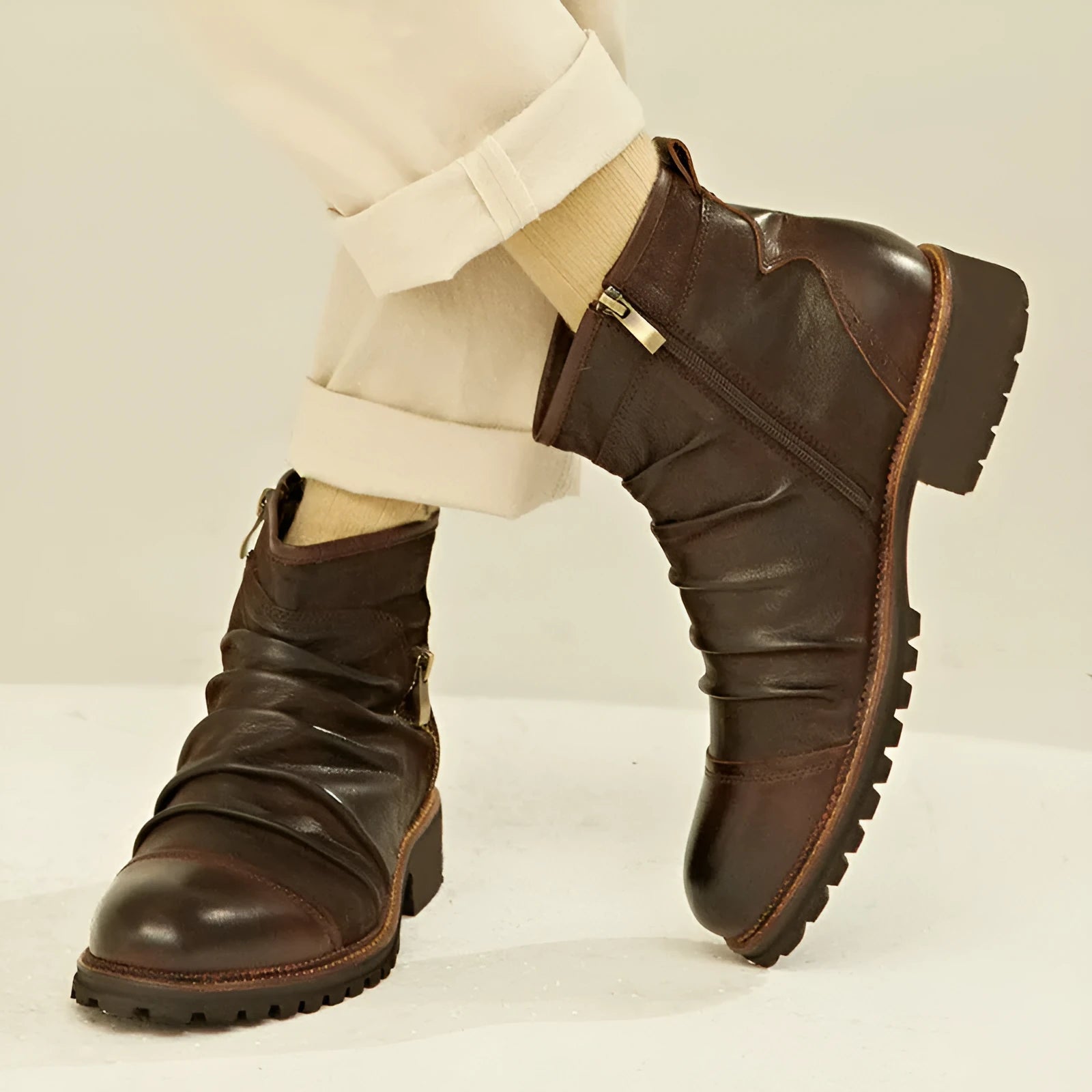 Black mid-height cowboy boots with side zipper, round toe, and a low horseshoe heel on a white background.