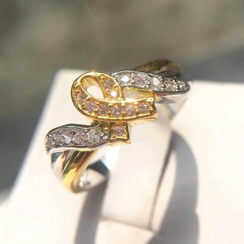 18k yellow gold plated ribbon ring with pink bare stone inlay, geometric unisex design, US sizes 5 to 11.