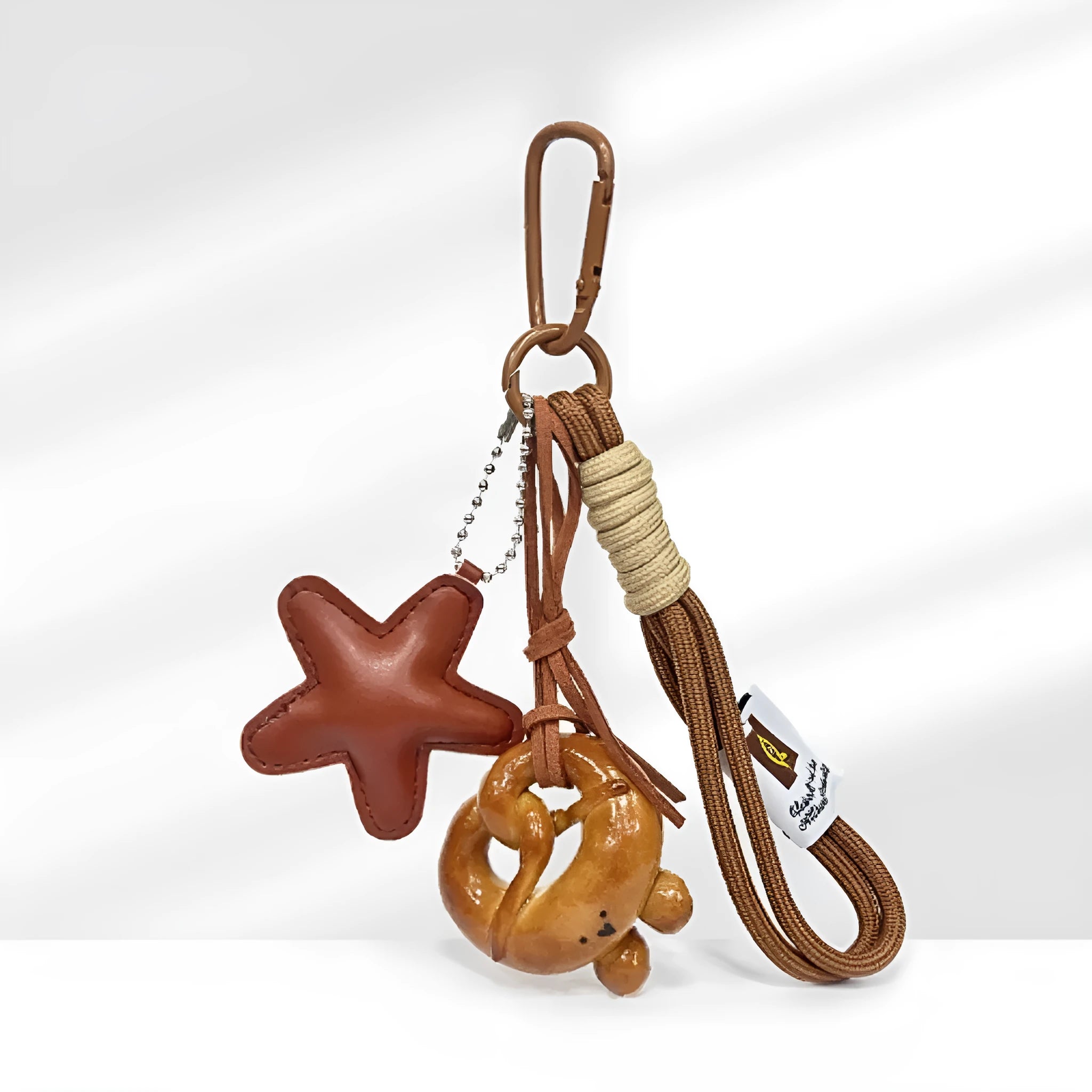Handmade soda bread handbag pendant charm with cartoon bread designs on brown leather strap