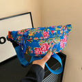 Western style women's waist bag with floral design in black, measuring 32cm wide with 3D pockets