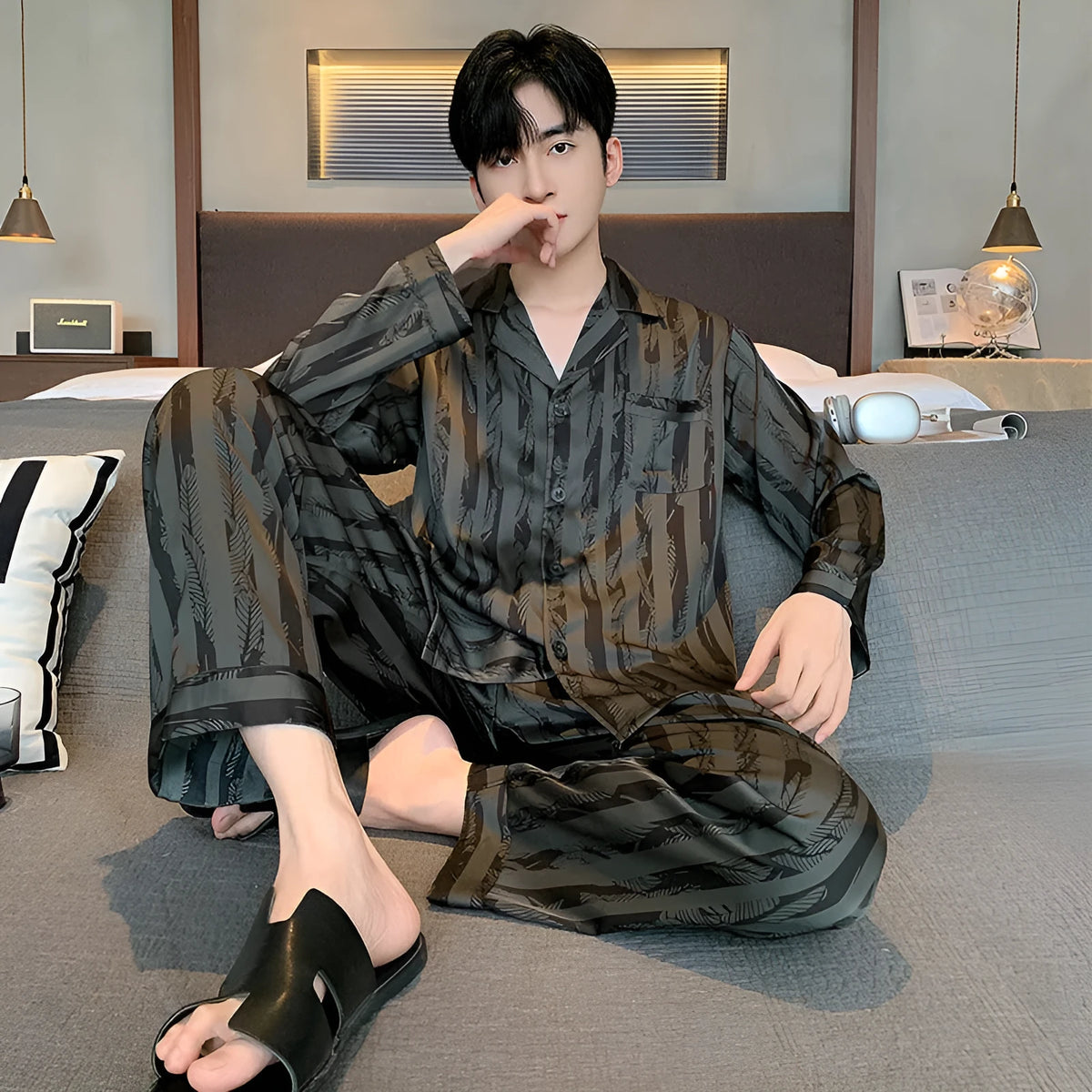 Black striped men's ice silk two-piece pajama set with V-neck top and long trousers.