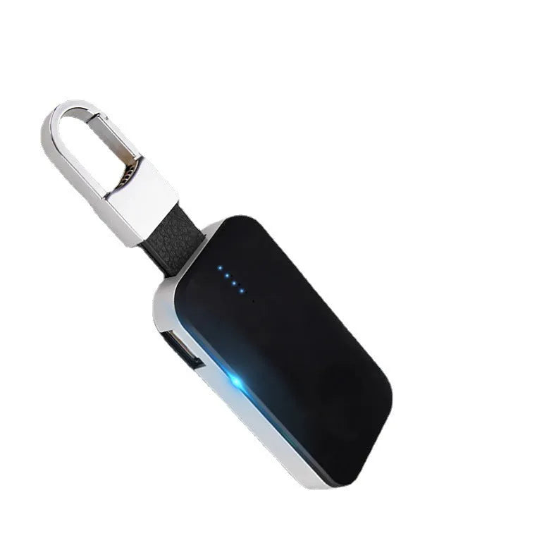 Black ABS Apple Watch wireless charging power bank on a keyring, shown next to an Apple Watch.