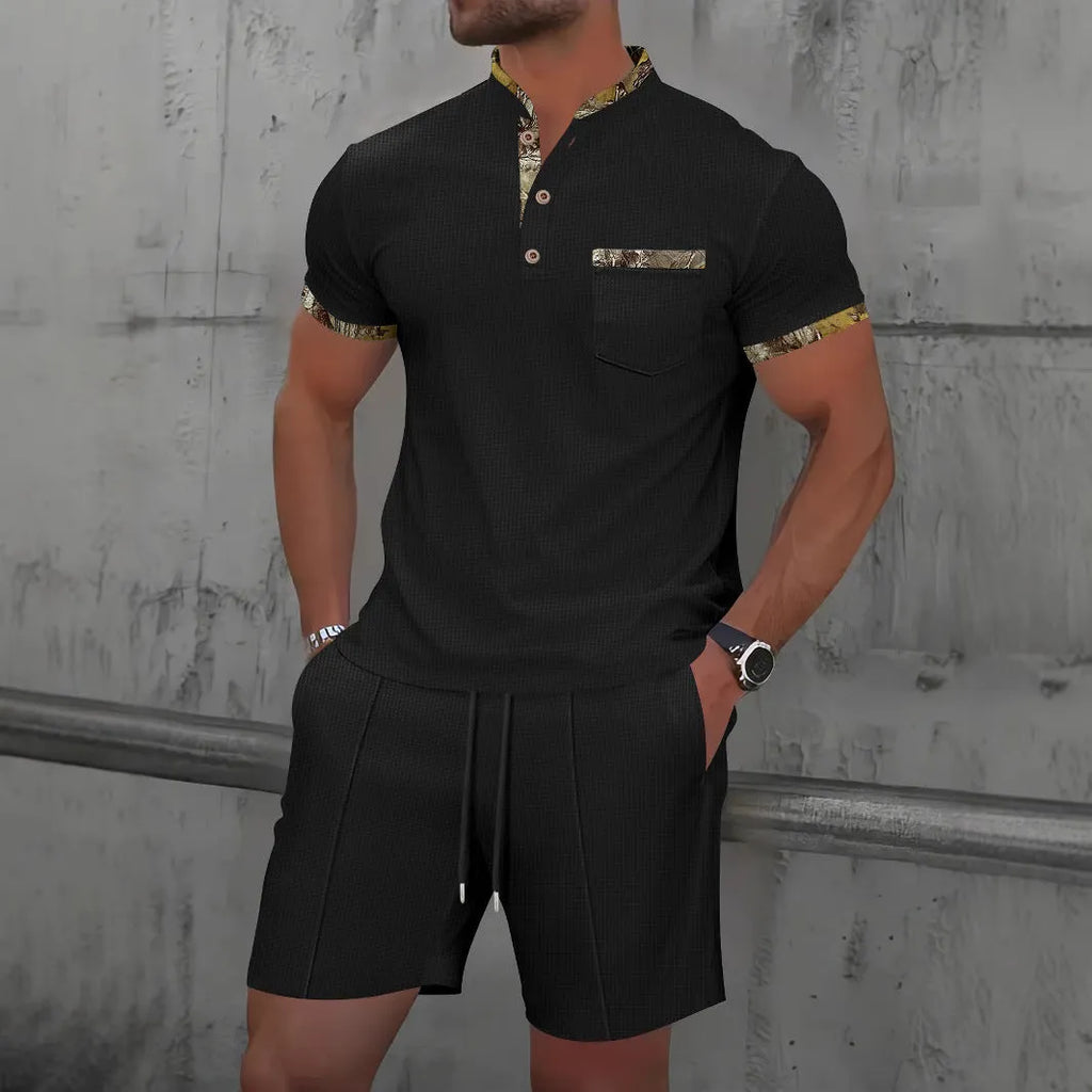 Man modelling a grey waffle knit zip-up polo short sleeve top and matching shorts.