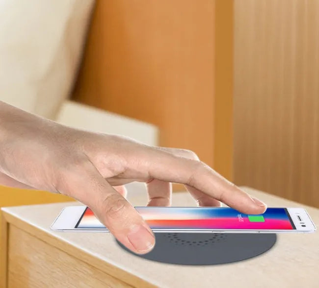 Black round 60mm diameter wireless phone charger for embedding into desk or table surface.