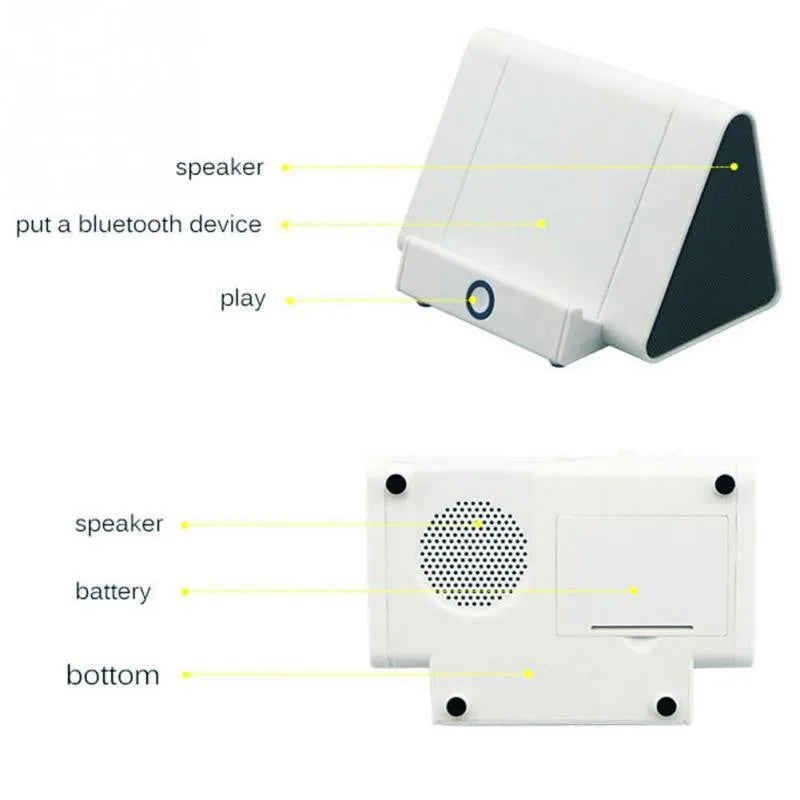 Small black and white wireless Bluetooth mini speaker with built-in charging cable.