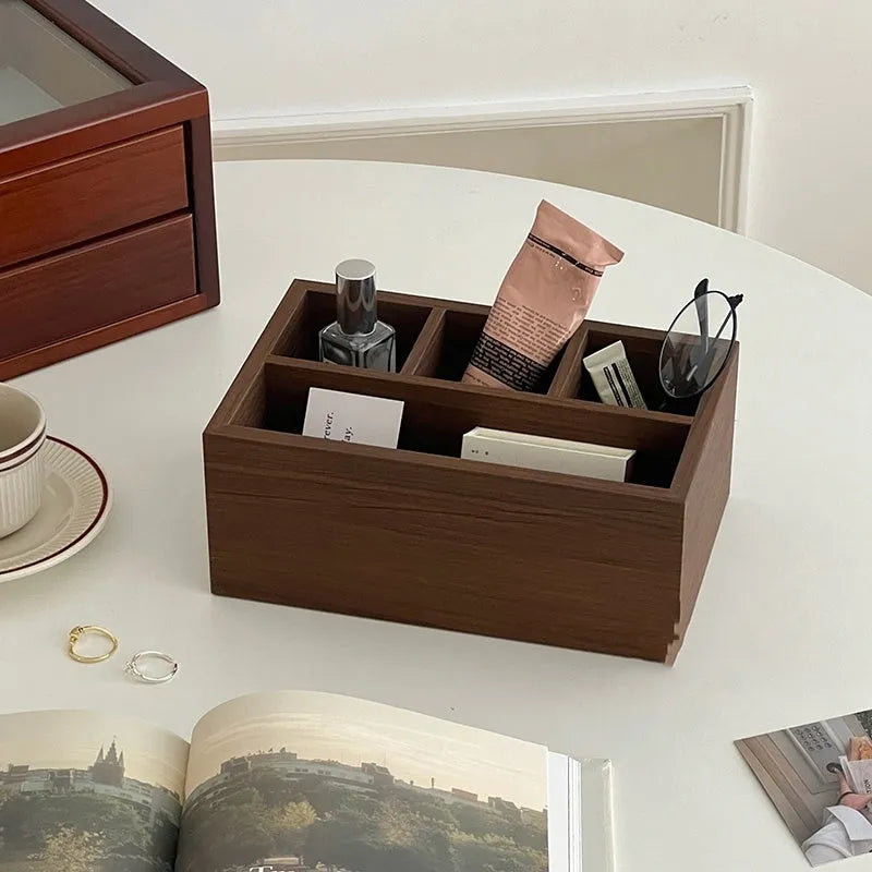 Retro wood desktop grid storage box with four short cells on a desk organising pens and sundries