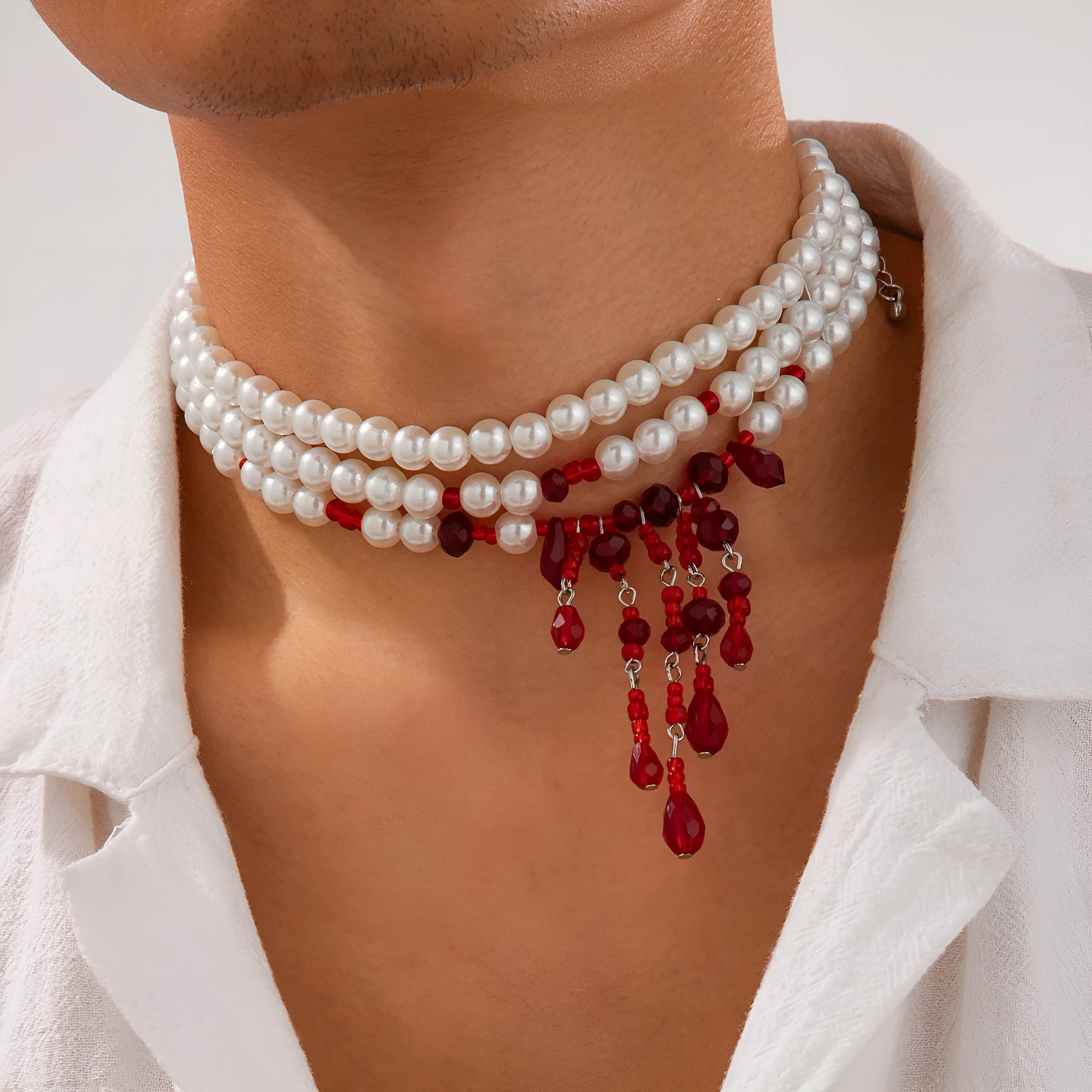 Men's blood drop tassel necklace with geometric crystal pendant and imitation pearls on a chain.